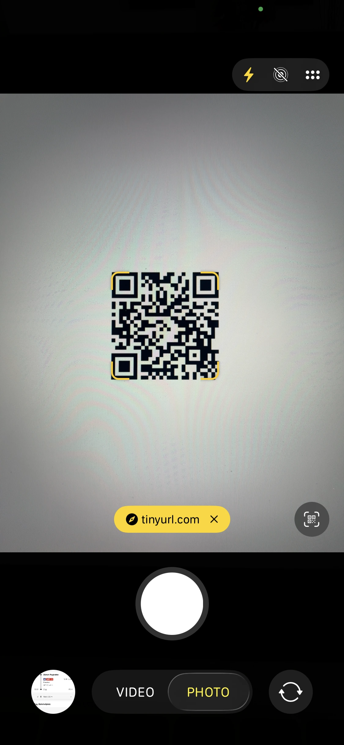 An iPhone camera detecting a QR code; the only information it shows is a 'tinyurl.com' tag.